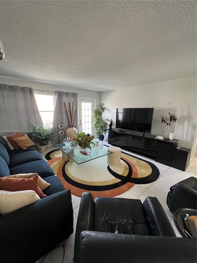 tiled living room featuring a textured ceiling