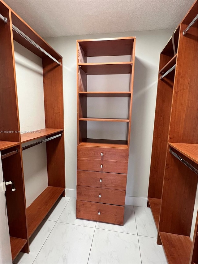 walk in closet featuring light tile patterned floors