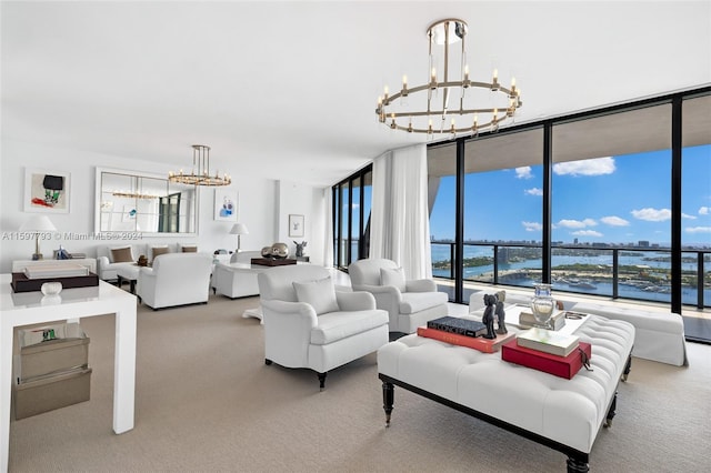 carpeted living room with floor to ceiling windows, a water view, and a chandelier