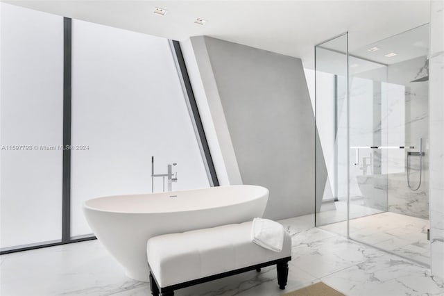 bathroom featuring tile patterned flooring and shower with separate bathtub