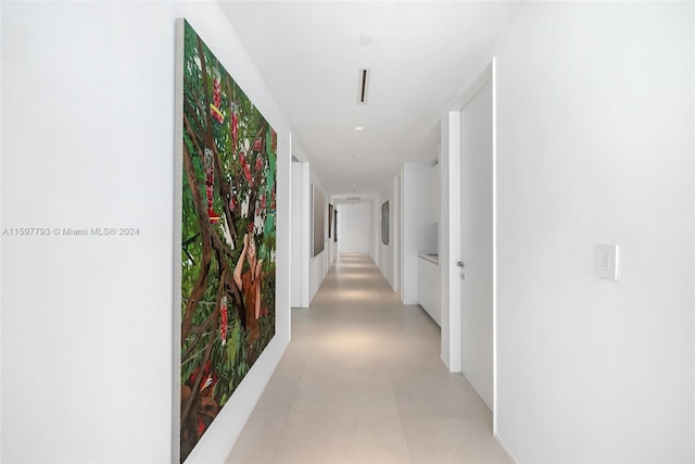 corridor with light tile patterned floors