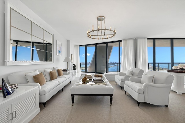 living room featuring carpet flooring, a wall of windows, and a chandelier