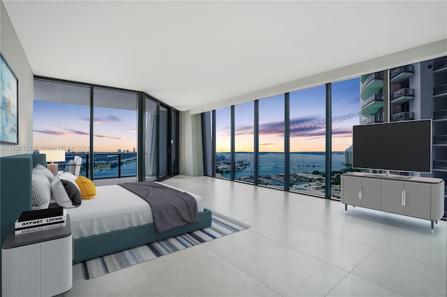 tiled bedroom with expansive windows and access to exterior