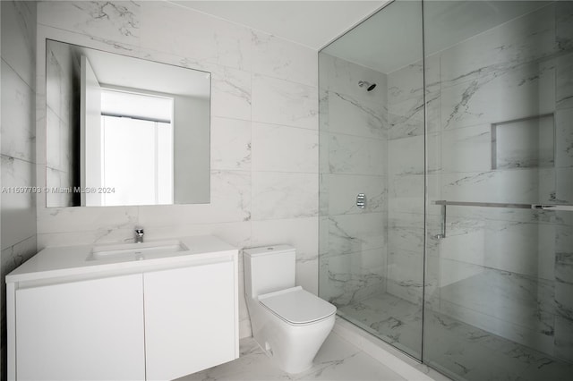 bathroom with toilet, vanity, and tile walls