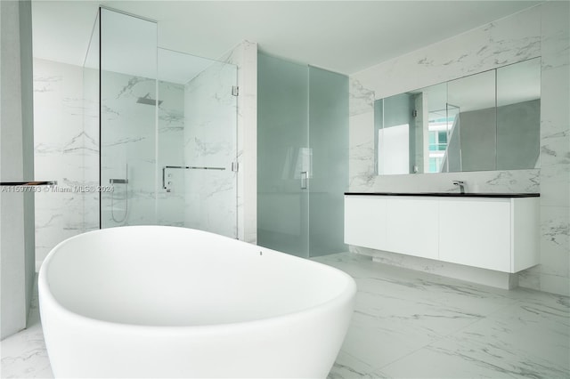 bathroom featuring tile walls, shower with separate bathtub, vanity, and tile patterned floors