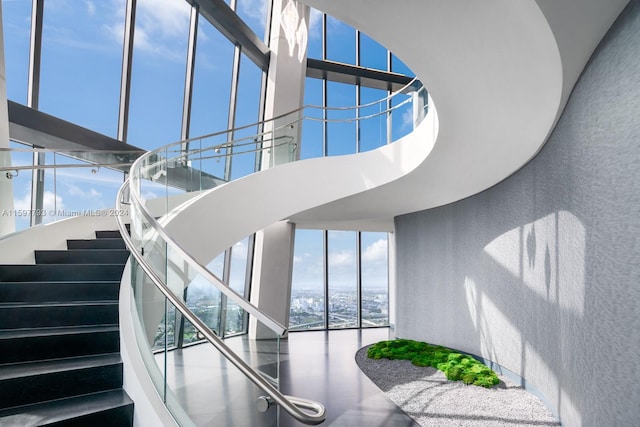 staircase featuring a high ceiling