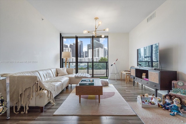 living room featuring dark wood-type flooring, expansive windows, and a notable chandelier