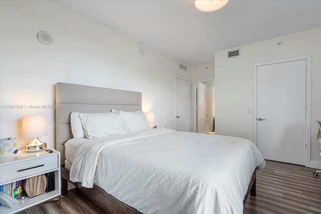 bedroom with dark hardwood / wood-style floors