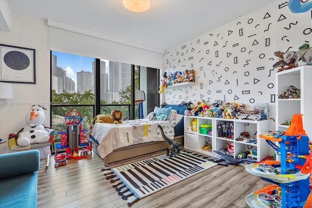 bedroom featuring hardwood / wood-style floors and expansive windows