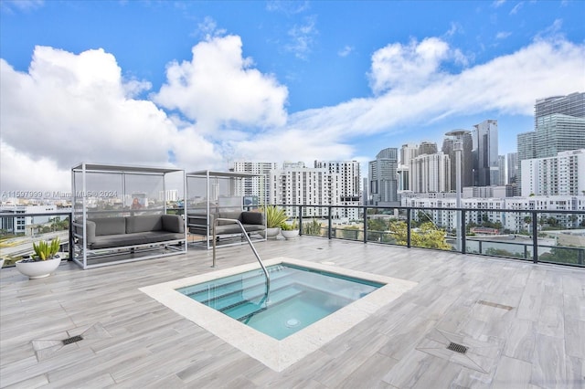 view of swimming pool featuring a hot tub