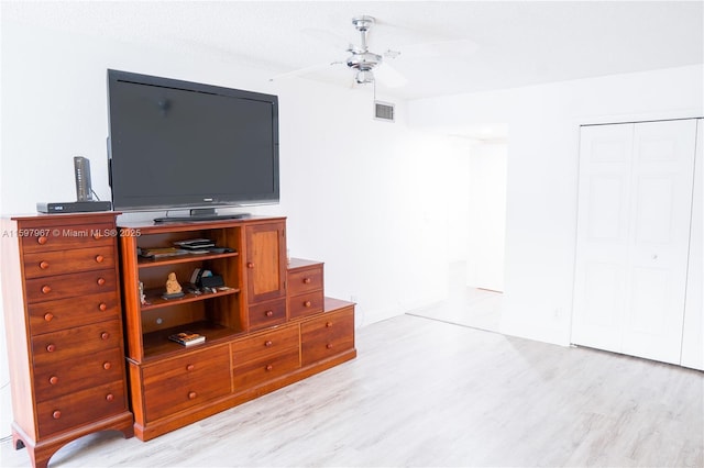 interior space featuring a closet, ceiling fan, and light hardwood / wood-style flooring