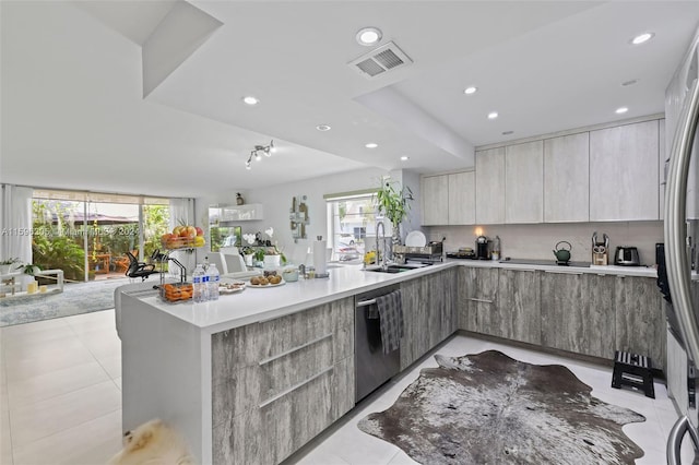 kitchen with sink, light tile patterned floors, and stainless steel appliances