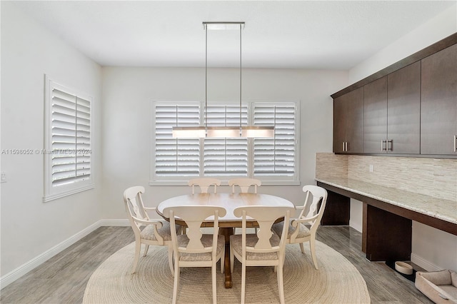 dining area featuring a wealth of natural light and light hardwood / wood-style flooring