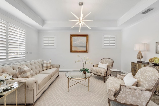 carpeted living room with a tray ceiling, crown molding, and a chandelier