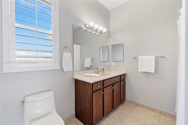 bathroom with toilet, vanity, and tile patterned floors