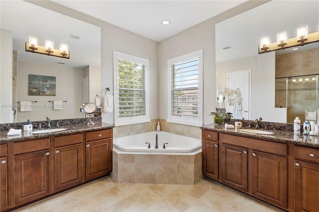 bathroom with tile patterned flooring, vanity, and independent shower and bath