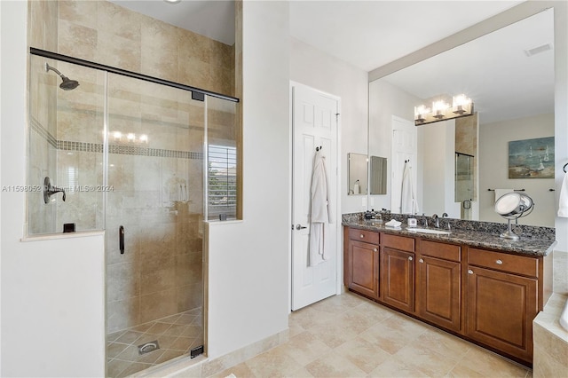 bathroom featuring vanity and an enclosed shower