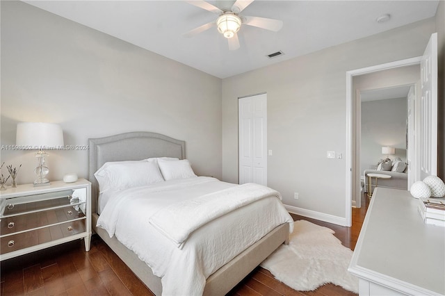 bedroom featuring ceiling fan, dark wood-type flooring, and a closet