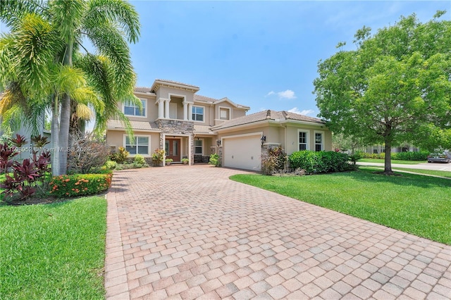 mediterranean / spanish house with a front yard and a garage