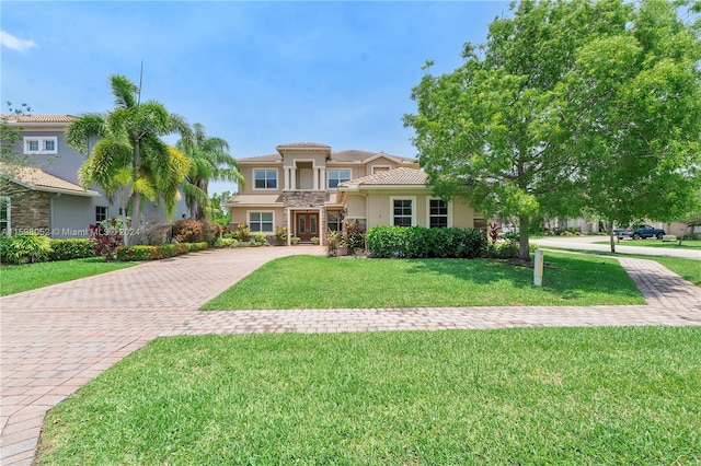 mediterranean / spanish-style house with a front yard