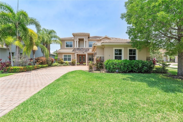 mediterranean / spanish home with a front lawn