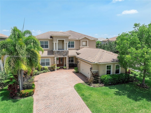 mediterranean / spanish-style house featuring a garage and a front lawn