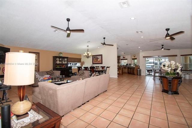 living room featuring a notable chandelier and light tile patterned flooring