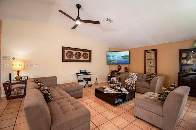 living room featuring ceiling fan, light tile patterned floors, and lofted ceiling