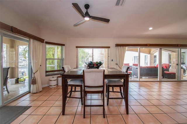 tiled dining area featuring ceiling fan