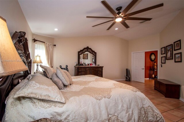 bedroom with ceiling fan, light tile patterned floors, and vaulted ceiling