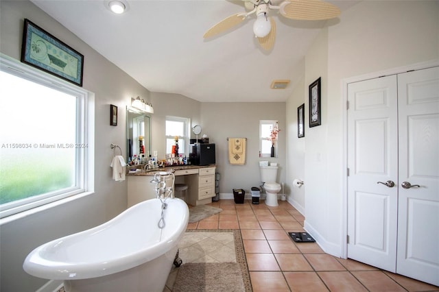 bathroom featuring vanity, a tub to relax in, tile patterned floors, and ceiling fan