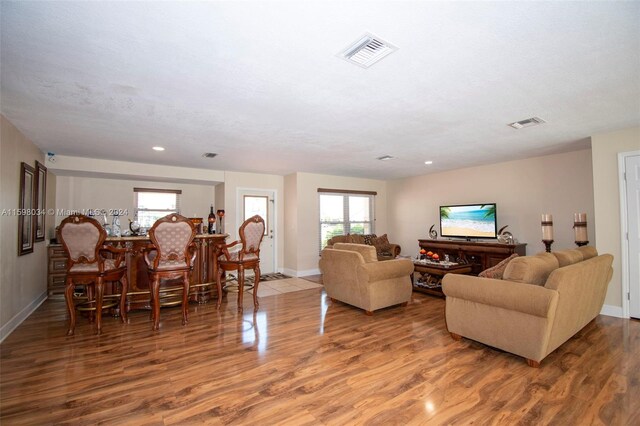 living room with hardwood / wood-style floors and a textured ceiling