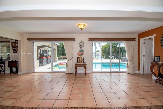 doorway featuring light tile patterned flooring