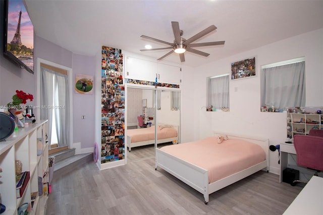 bedroom featuring a closet, ceiling fan, and light hardwood / wood-style flooring