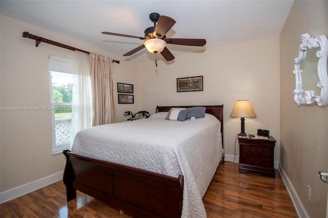 bedroom with dark hardwood / wood-style floors and ceiling fan