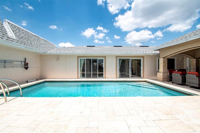 view of swimming pool featuring an outdoor living space and a patio area