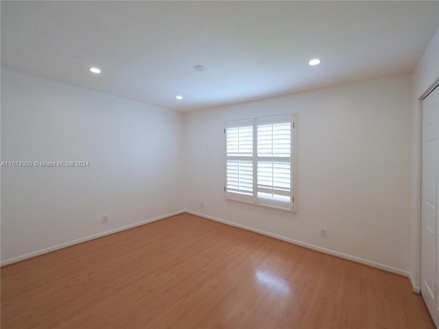 spare room featuring wood-type flooring