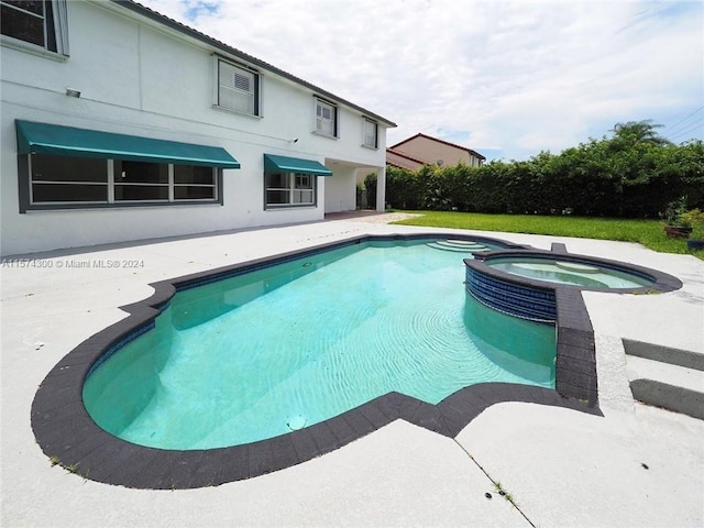 view of pool featuring an in ground hot tub and a patio