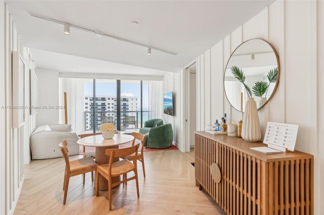 dining room featuring lofted ceiling and track lighting