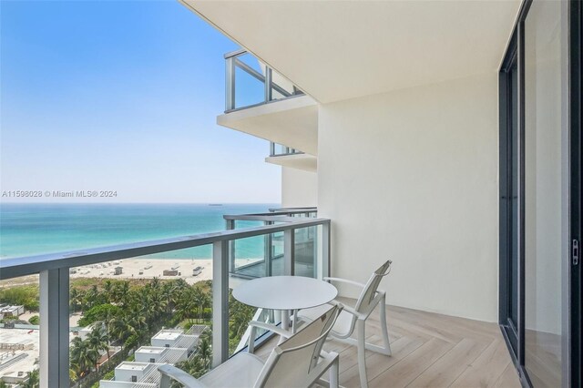 balcony with a view of the beach and a water view