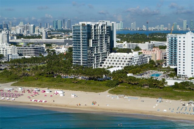 birds eye view of property with a view of the beach and a water view