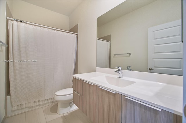 bathroom featuring tile patterned flooring, vanity, and toilet