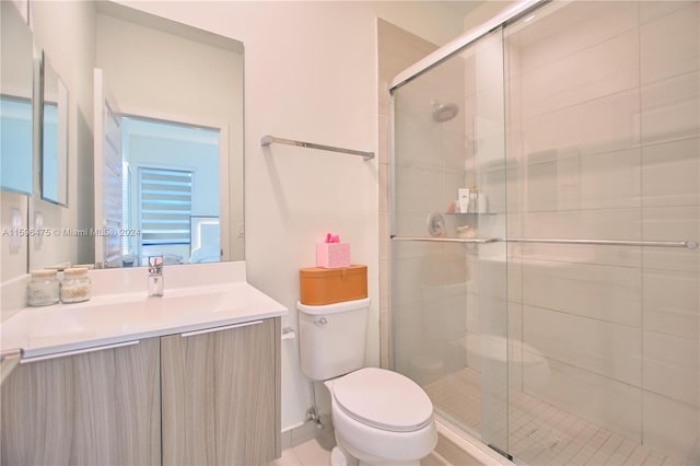 bathroom with vanity, toilet, and an enclosed shower