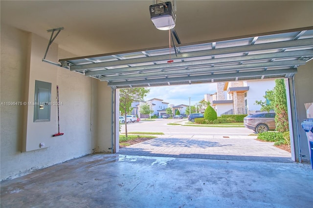 garage with electric panel and a garage door opener