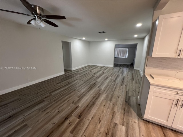 unfurnished living room featuring ceiling fan and light hardwood / wood-style flooring