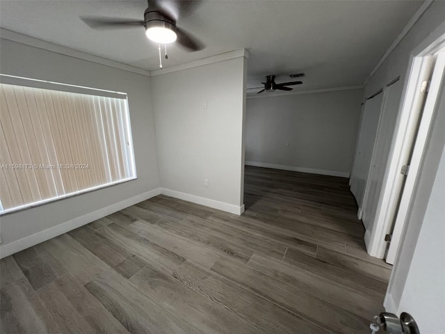 spare room with ceiling fan, ornamental molding, and wood-type flooring