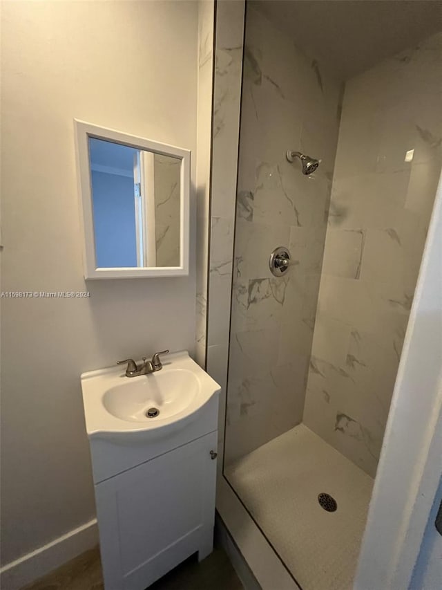 bathroom with vanity and tiled shower