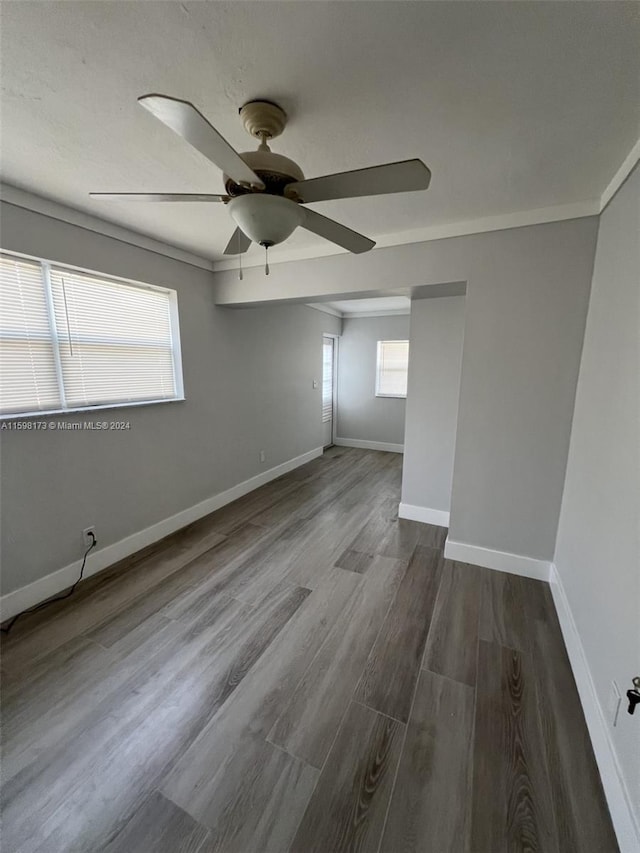 spare room with ceiling fan, crown molding, and hardwood / wood-style flooring