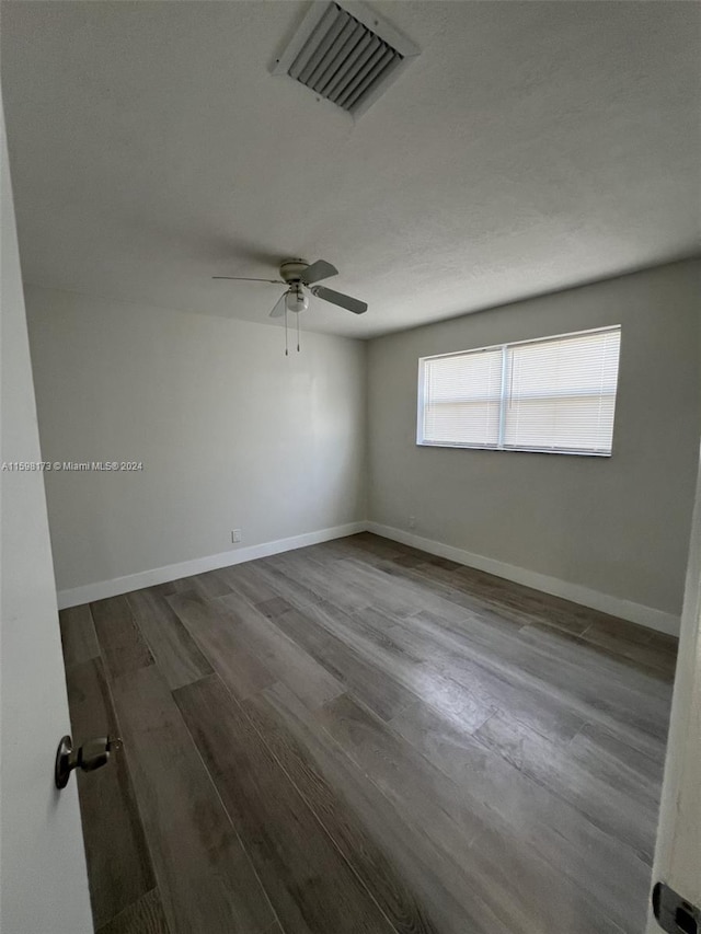 unfurnished room with ceiling fan and hardwood / wood-style flooring