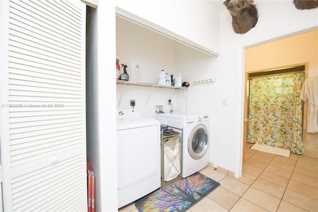 washroom with light tile floors, independent washer and dryer, hookup for an electric dryer, and washer hookup